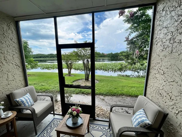 Virtually staged screened-in back porch with soothing water views to Lake Pearl