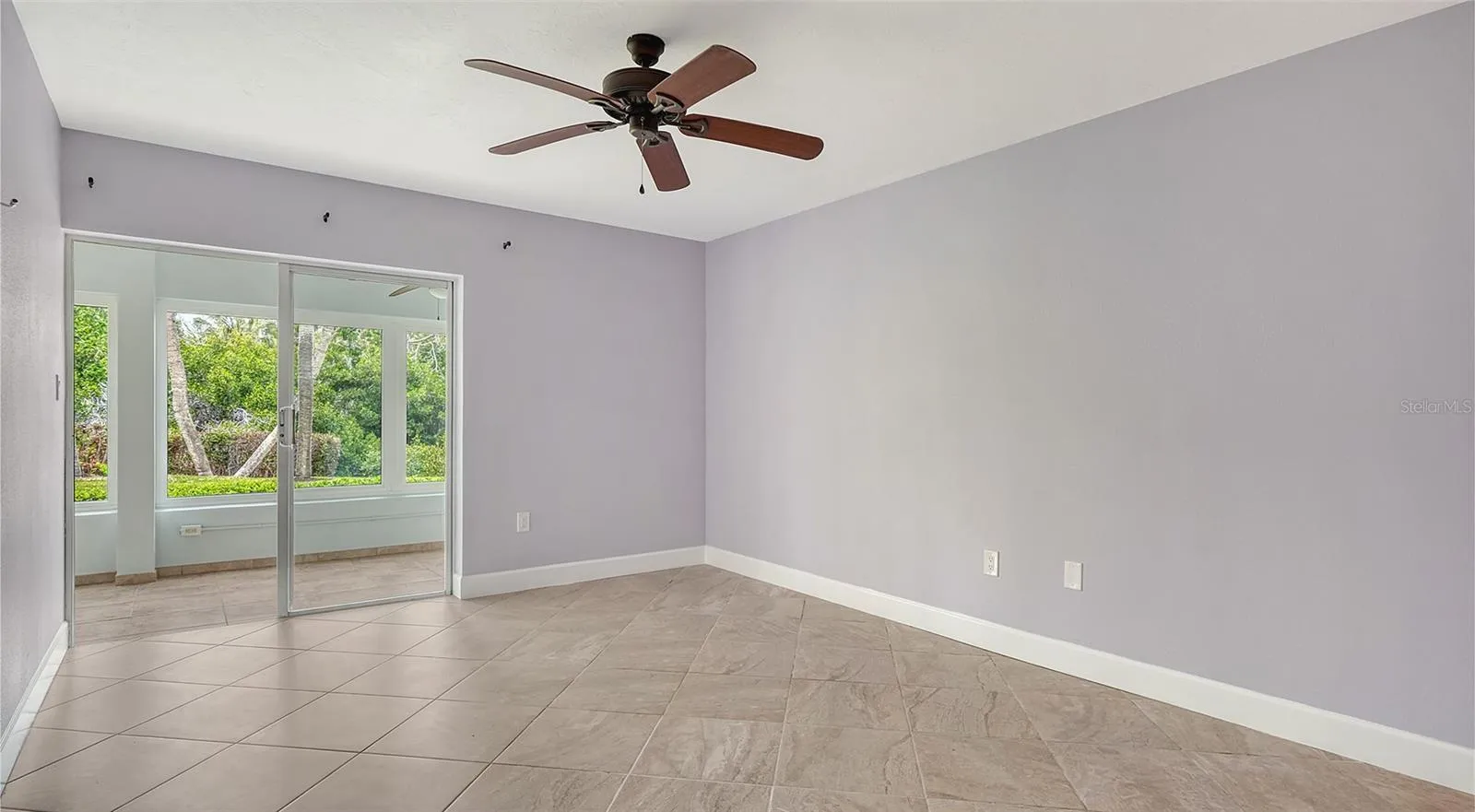 Primary bedroom with sliders leading to the lanai.