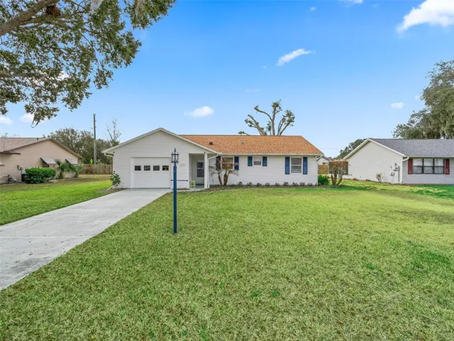 FRONT VIEW WITH LONG DRIVEWAY