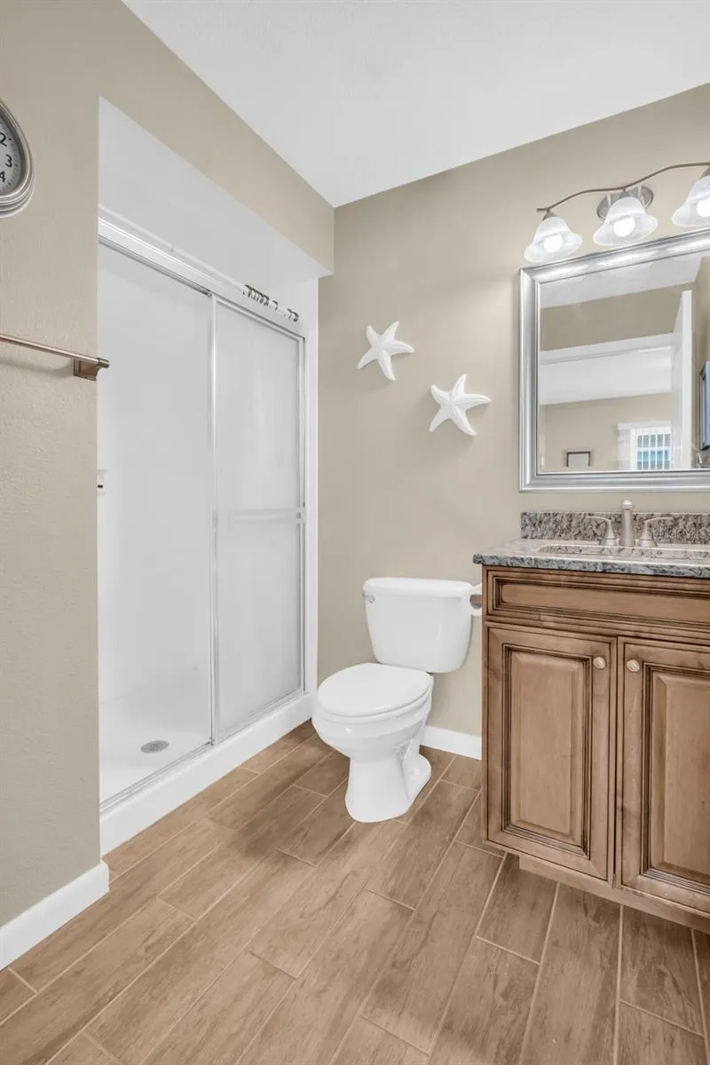 Updated guest bath with walk-in shower, newer vanity, granite countertop, &amp; tasteful lighting~