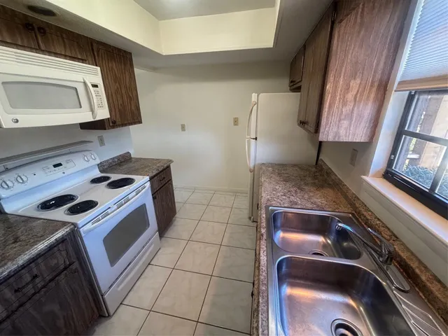 Galley style kitchen with high ceilings