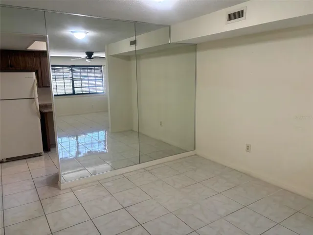 Open dining area into the large, tiled living room