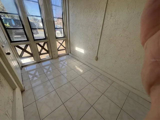 Bright indoor private patio overlooking the front coutyard.