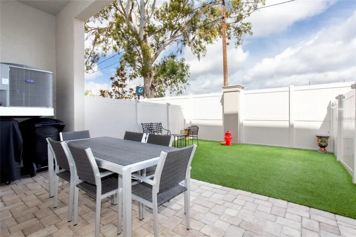 First Level exit from garage fenced in area with turf