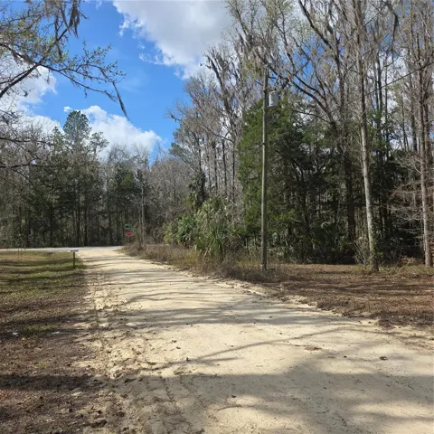 Very close to the stop sign on paved road that give access to property.