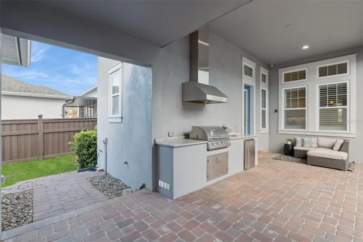 A huge backyard with covered outdoor porch and outdoor entertaining area perfect for keeping as it is to add a pool.