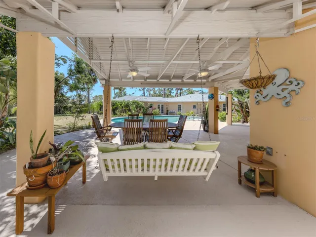 Dining area and porch swing under the cabana