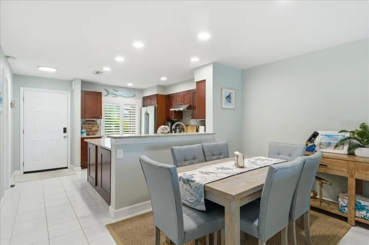 Dining area just off kitchen with convenient counterspace for serving and views out the wall of sliding glass doors to the balcony.