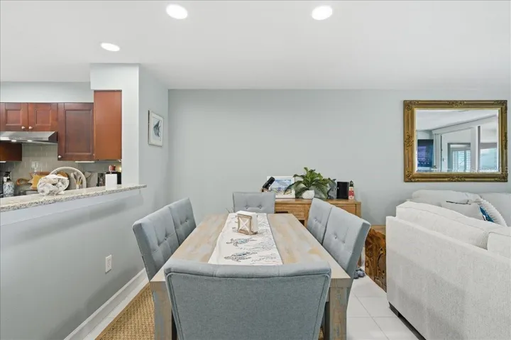 Dining area just off kitchen with convenient counterspace for serving and views out the wall of sliding glass doors to the balcony.