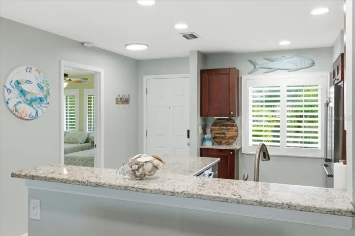 Kitchen just off the front entry and second bedroom with en-suite bath at front of home for convenient split bedroom plan privacy