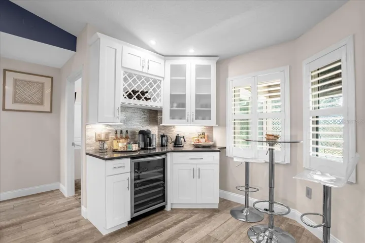 breakfast nook with wine rack and fridge