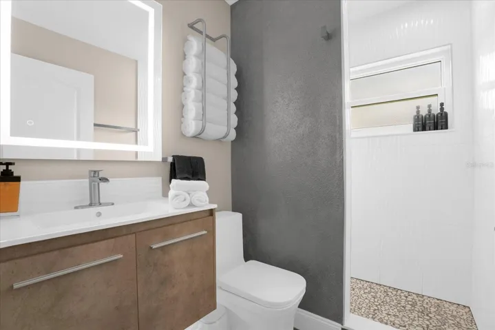 floating vanity, fog free mirror and walk in shower