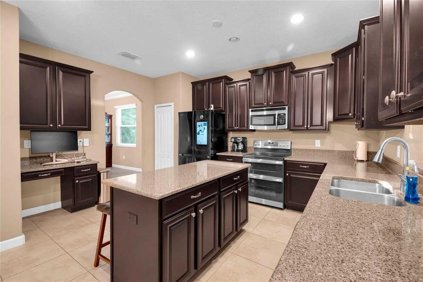 Kitchen has a built-in desk and double ovens
