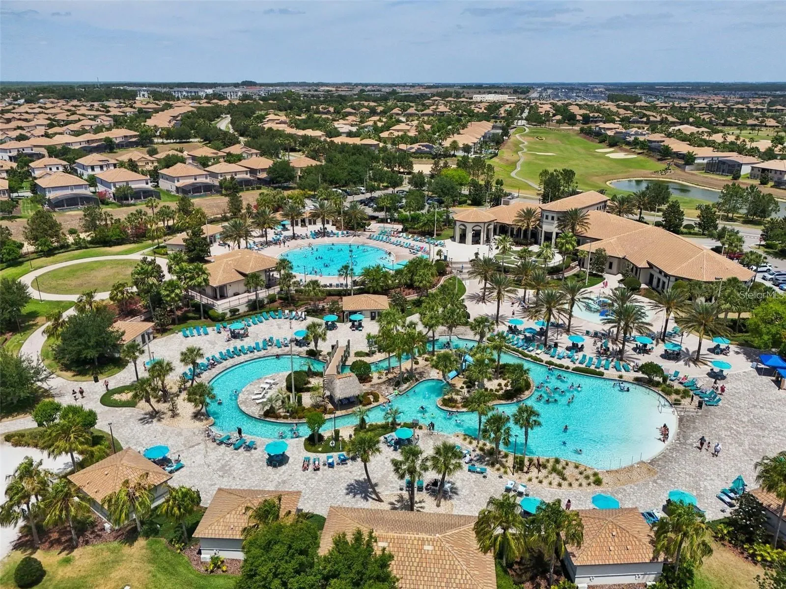 Oasis Club with lazy river, community pool, kids splash zone, two bars, restaurant, arcade, gym, and movie theater