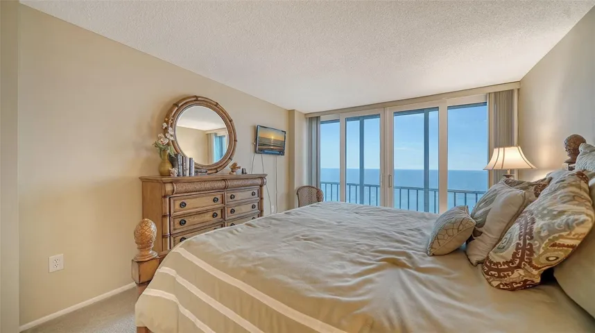 The primary bedroom has a view that makes you want to stay in bed and enjoy it...