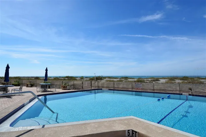 The heated pool is just steps to the beach...