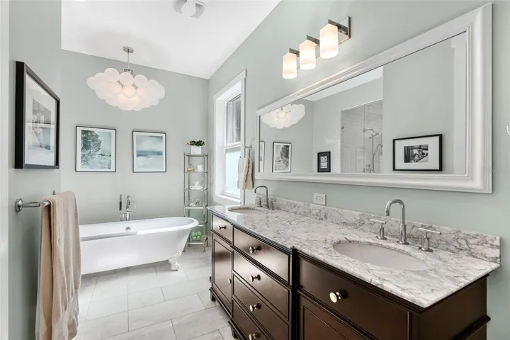 Marble topped vanity and dual sinks in the primary bath. All Kohler fixtures.