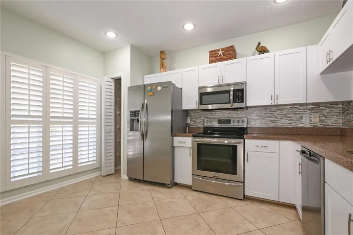 Enjoy everyday luxury with granite countertops and dazzling refaced cabinets in kitchen