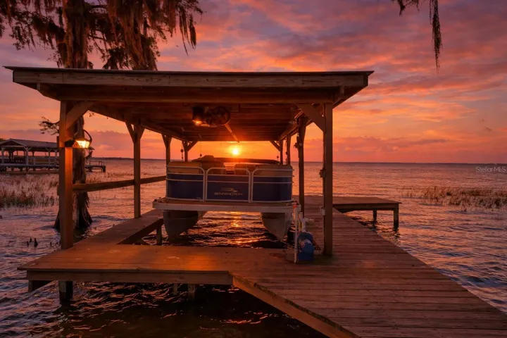 Private dock on Lake Eustis with sunset views, boat lift, and direct access to the Harris Chain of Lakes