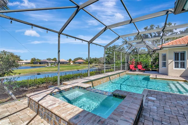 pool and spa with golf and water views