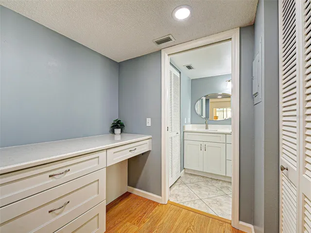 The desk area is in front of the walk in closet