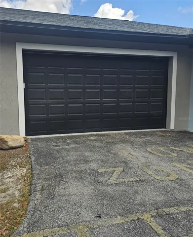 Double garage with overhead door for use with the unit
