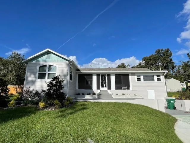 Front view with large concrete driveway