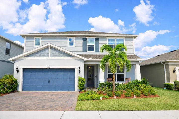 Extended paver driveway, covered entry, and inviting curb appeal.