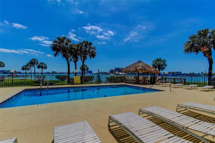 Pristine pool with Tiki hut.