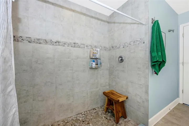 PRIMARY BATHROOM has walk-in shower with tile walls