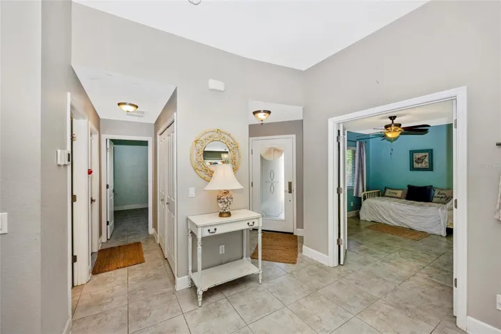 Foyer with room that has double doors to the left ready to be used as bedroom with closet or home office.