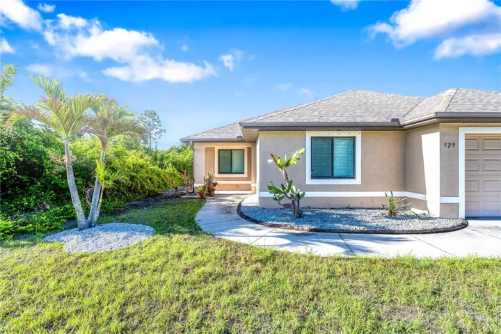 Landscaped with PALM TREES and shell.