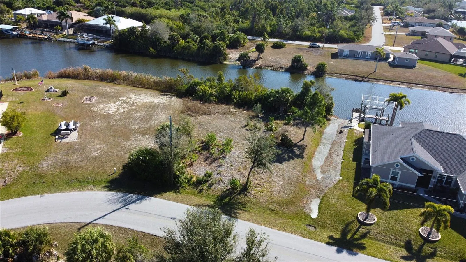 Aerial view of residential area featuring a nearby body of water