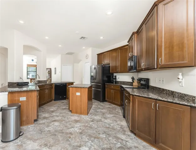 Great kitchen features wood cabinetry and granite countertops!