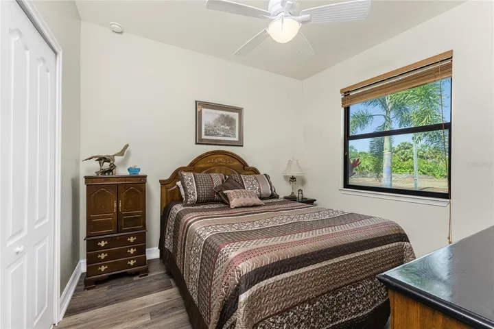 Guest bedroom #2 features a ceiling fan and wall closet