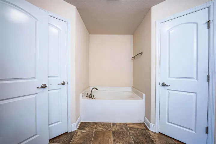Primary bathroom with two walk-in closets