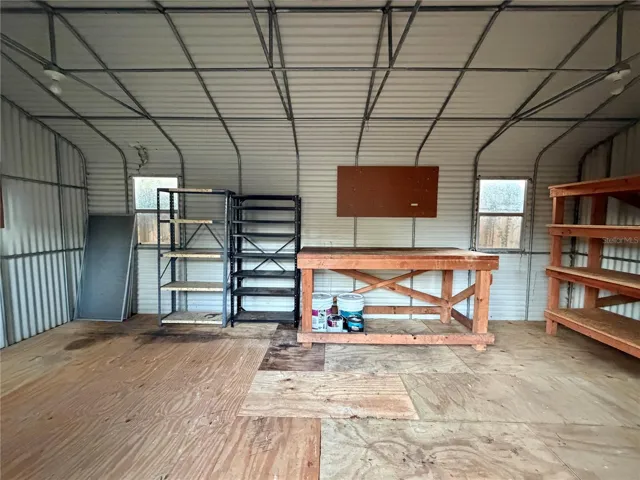 Extra large shed has pegboards and shelving.