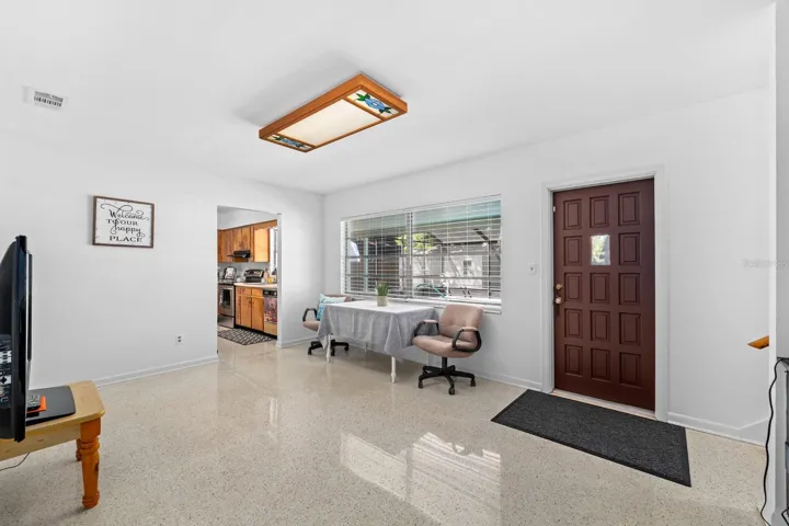 Living Room has terazzo floors and overlooks the pool through a large window.  The light can be easily replaced with a ceiling fan.