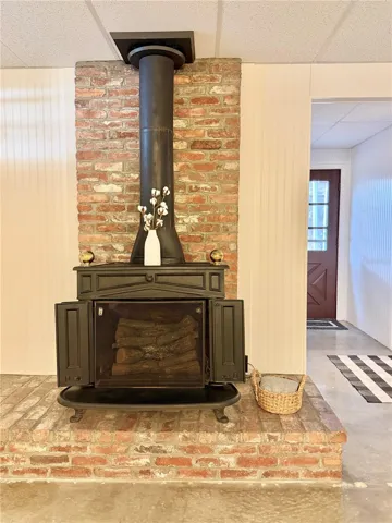 The Bonus Room also features a vintage fireplace with a brick mantel.