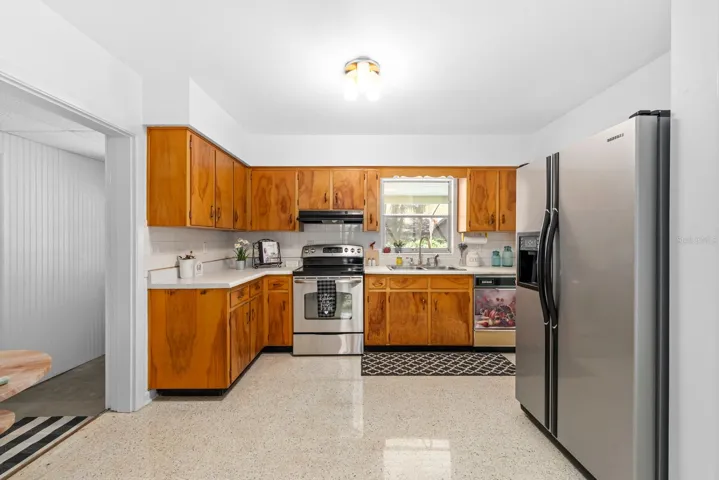 Very spacious kitchen with eat-in area and also features the same terazzo floors.