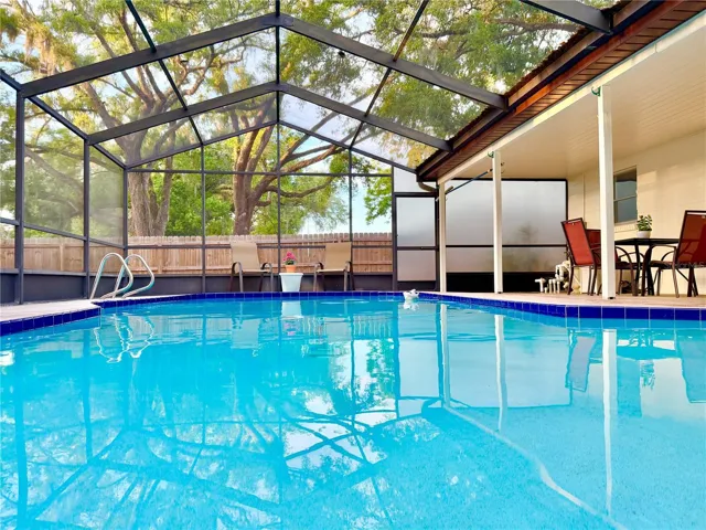 Beautiful, oversized pool and pool cage for entertaining.
