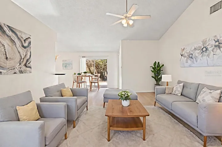 Virtually Staged Living Room with High Ceilings and Luxury Vinyl Plank flooring