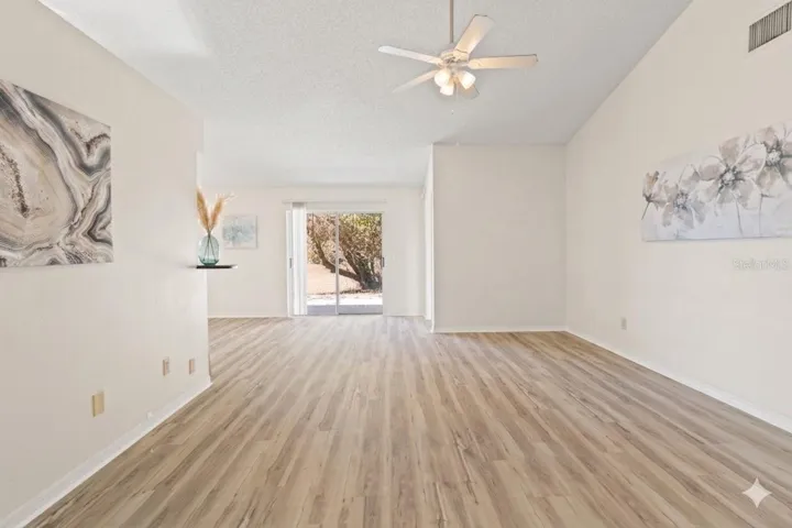 From the entryway.  Living room with new flooring and tall ceilings