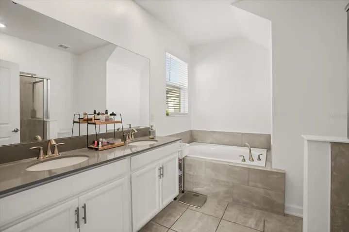 Primary bathroom with dual sinks and ample counter space.