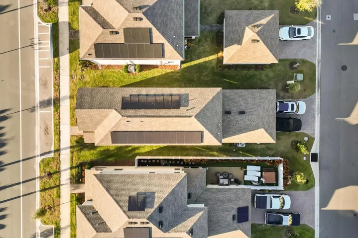 Aerial view of home and surrounding pond.