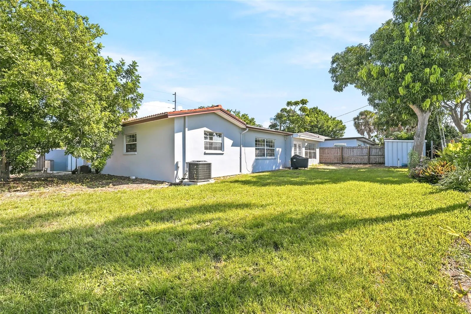 Room to enjoy the outdoors, with a broad backyard lawn and mature trees creating an inviting setting for gardening, games, or weekend gatherings.