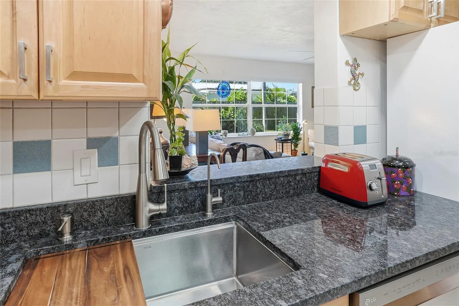 Stay part of the conversation while preparing meals, with an open pass-through overlooking the bright family room and its leafy backyard views.