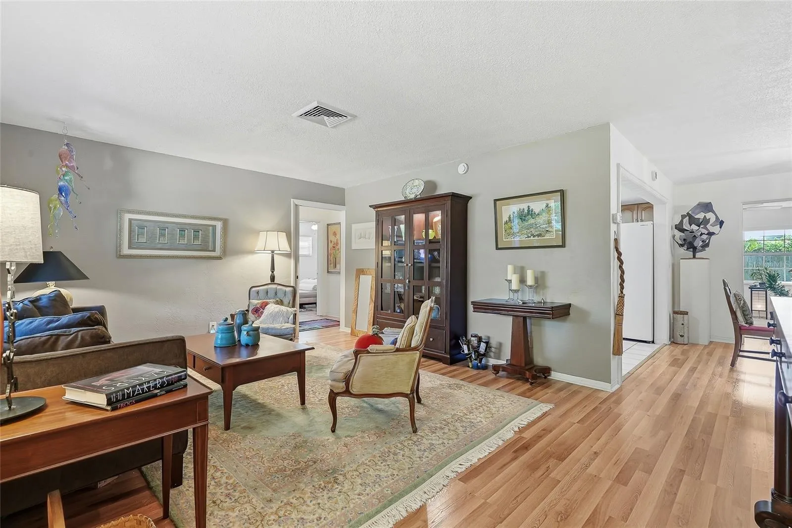 Room to gather and unwind. The spacious living room offers flexible furniture arrangements and easy access to the kitchen, dining area and guest bedrooms, separated by a working pocket door.