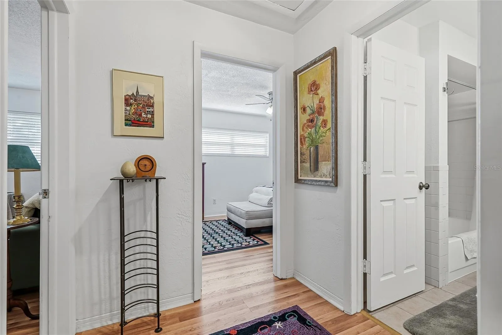 Two additional bedrooms and a shared bath are grouped together off their own hallway, creating a comfortable setup for guests or a bedroom and home office.
