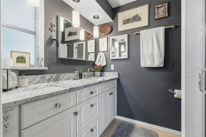 Start your day with generous vanity space, plentiful drawer storage, and pendant lighting that adds a stylish touch to the primary bath.